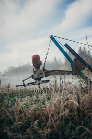 a vertical shot of an agricultural harvester in the field