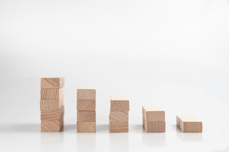 A wooden blocks stacking as a step stair isolated on a white backgroundの写真素材