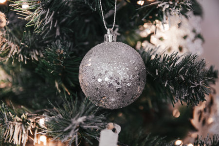 A closeup of beautiful silver ornaments on a festive Christmas treeの写真素材