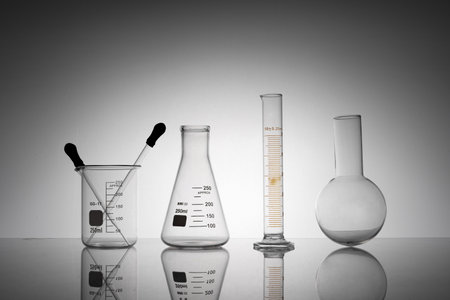 A closeup shot of laboratory flasks, beakers, and tubes