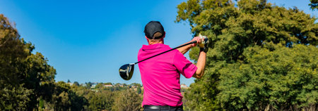 A wide shot of a professional player playing golfの写真素材