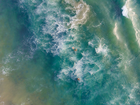 A top view shot of people swimming in Varkala Beach