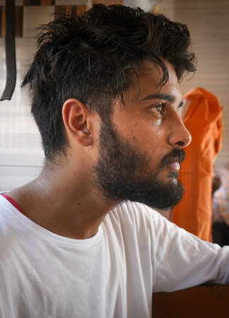 A vertical closeup shot of an angry Indian man