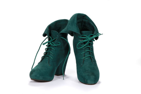 A pair of green suede female shoes isolated on a white backgroundの写真素材