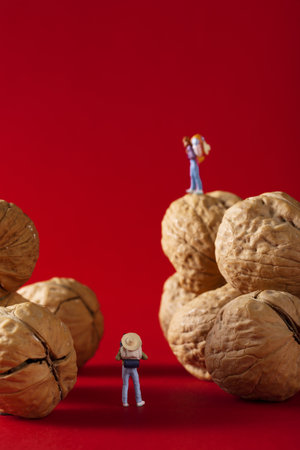 A vertical shot of 3D toys of people and walnutsの写真素材
