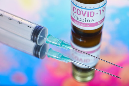 A Covid-19 vaccine and syringe injection - stop pandemicの写真素材