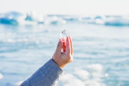 A hand holding a piece of ice Diamond Beach, Icelandの写真素材