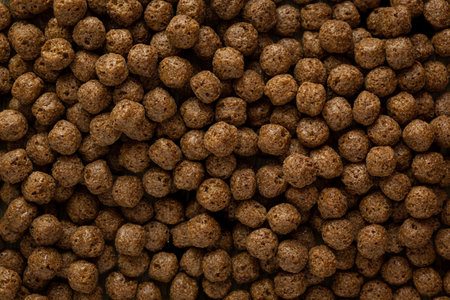 A top view of a pile of sweet and tasty chocolate cereal balls for breakfast