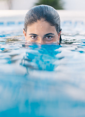 A vertical shot of a young lady in the waterの写真素材
