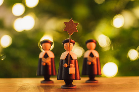 A selective focus shot of a small wooden Christmas star singers toys