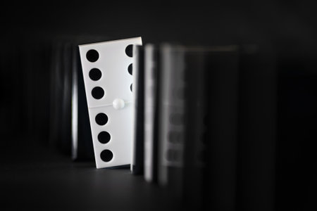 A symbolic photograph , represented by a shy domino piece showing in front of the othersの写真素材