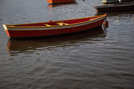 An old empty wooden rowboat on a lakeの写真素材