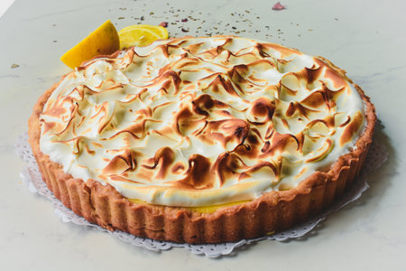 A lemon cake on Italian marble decorated with lemon wedgesの写真素材
