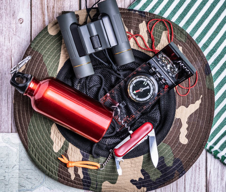 A top view shot of hiking equipment in a camouflage hatの写真素材
