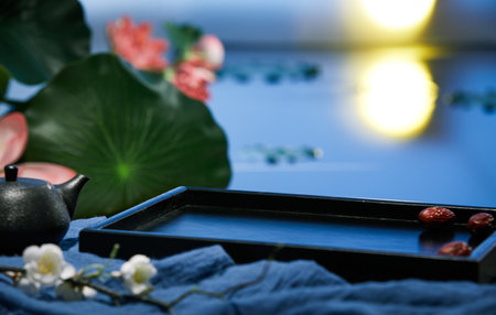 An empty plate, dried fruits, and a kettle of herbal teaの写真素材