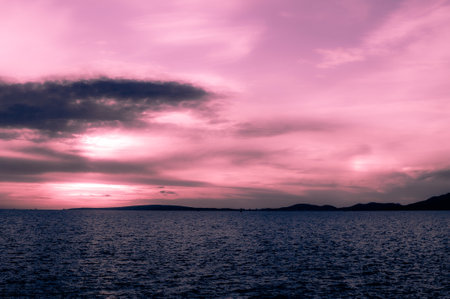 The breathtaking view of the purple sky above the ocean in Mallorcaの写真素材