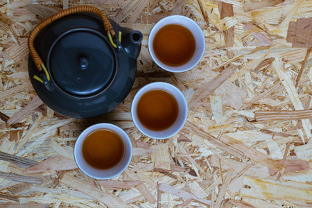 A top view of gray tea set on a pressed wooden panel surfaceの写真素材