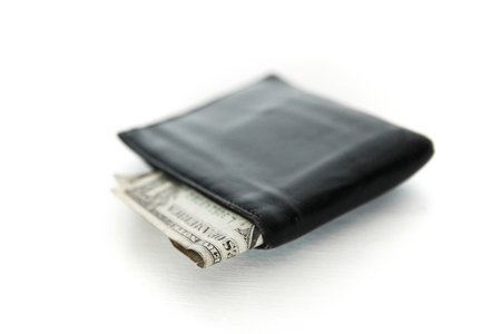 A black wallet with cash dollar isolated on white backgroundの写真素材