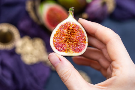 A closeup shot of a person holding a fresh figの写真素材