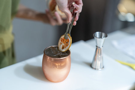 A closeup shot of a female making an exotic cocktail in the bar