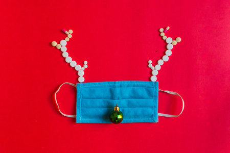 A festive Christmas reindeer made from face mask and decorationsの写真素材