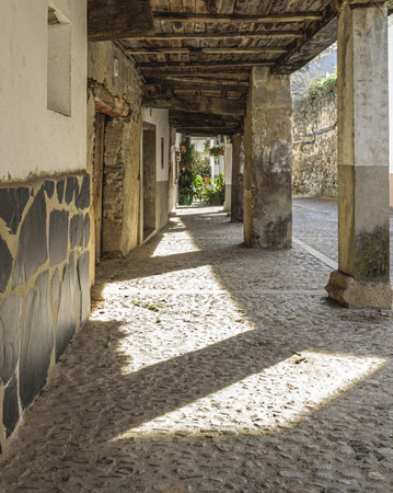 A vertical shot of a street arcade in Guadalupe, Spainの写真素材