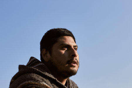 A young Hispanic man under the blue sky outdoors during daylight