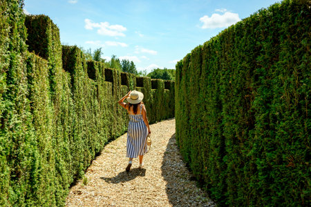 A beautiful white woman inside the grass labyrinth in the Arboretum Radomlje park in Sloveniaの写真素材