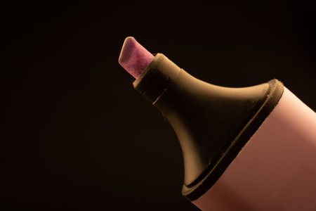 A closeup shot of a pink marker isolated on a dark backgroundの写真素材