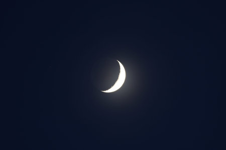 A low angle shot of the Moon with star Aldebaran at the left