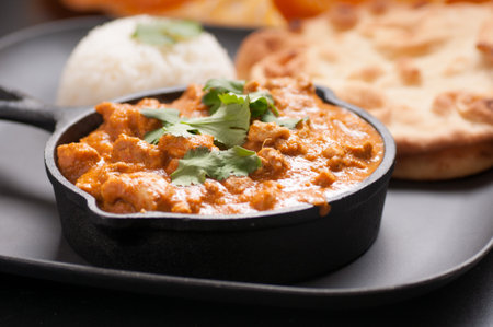 home made chicken korma with rice and naan breadの写真素材
