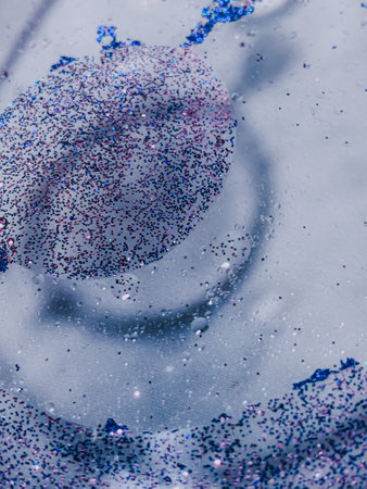 A vertical shot of blue glitters and waterdropsの写真素材