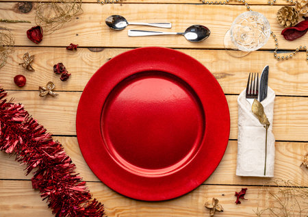 A top view of cutlery and plates on festive wooden backgroundの写真素材