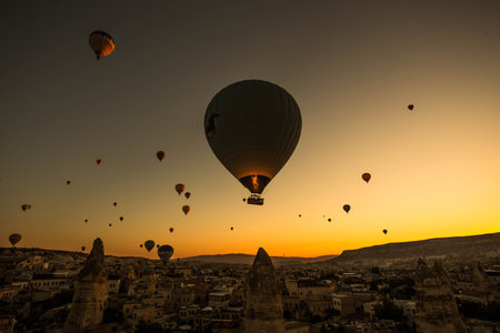 A stunning shot of hot air balloons flying over the Cappadocia region in Turkeyの写真素材