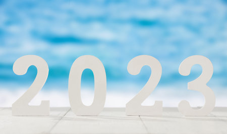 '2023' made with white plastic numbers on a blue background.