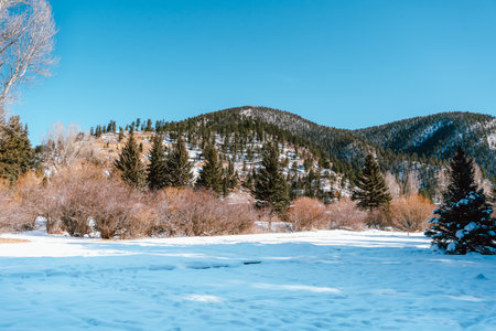 A beautiful view of the ground covered in the snow on the mountains covered in snow background