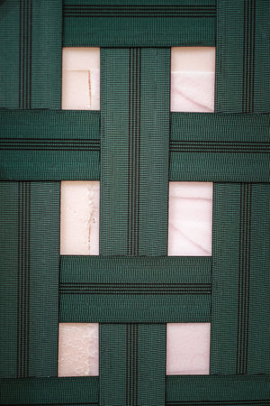 A closeup of woven elastic strap support of a sofaの写真素材