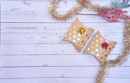 A flat lay of Christmas boxes on wooden backgroundの写真素材