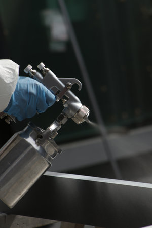 A vertical shot of a man in gloves sanitizing the interior - pandemic conceptの写真素材