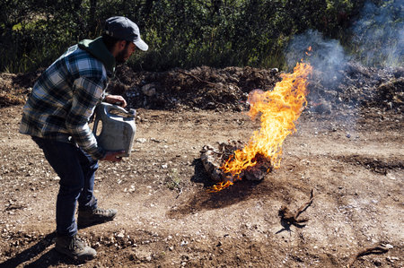 A shot of a man pouring oil on the fire