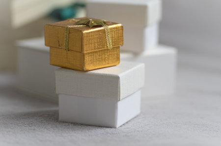 the tiny white and gold gift boxes on a white background