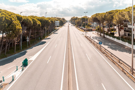 A view of an empty straight asphalt road on a cloudy day backgroundの写真素材