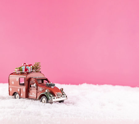 A closeup shot of a toy car for Christmas decoration on snowの写真素材