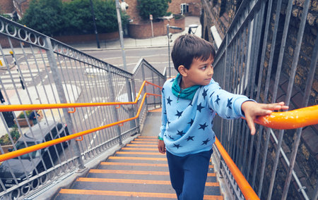 A little boy climbing up the stairsの写真素材