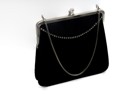 A closeup of a small black handbag isolated on a white backgroundの写真素材