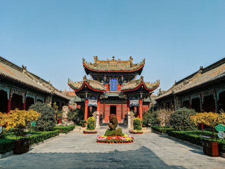 A historic Buddhist temple with a zen garden in China under a bright skyの写真素材