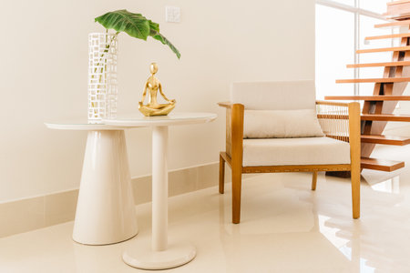A chair and table with modern decoratives in a living roomの写真素材