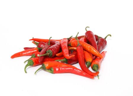 A pile of spicy peppers isolated on a white background
