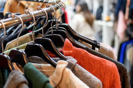A selective focus shot of clothes on hangers in a storeの写真素材