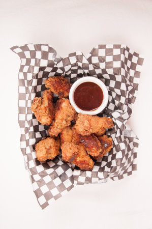 take away breaded chicken wings with bbq dipping sauceの写真素材